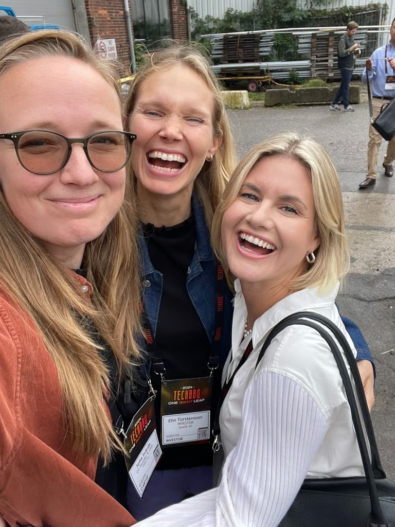 Three smiling women in a selfie at the TechBBQ conference